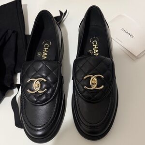 CHANEL Quilted Black Loafers with Gold Emblem